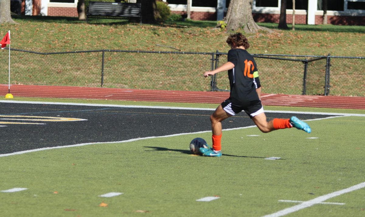 Junior Jack Steele takes a penalty kick against the Washington High School Blue Jays. This goal by Steele was the first of four goals for the Falcons. The team's 4-0 win moved them through to the second round of districts. 