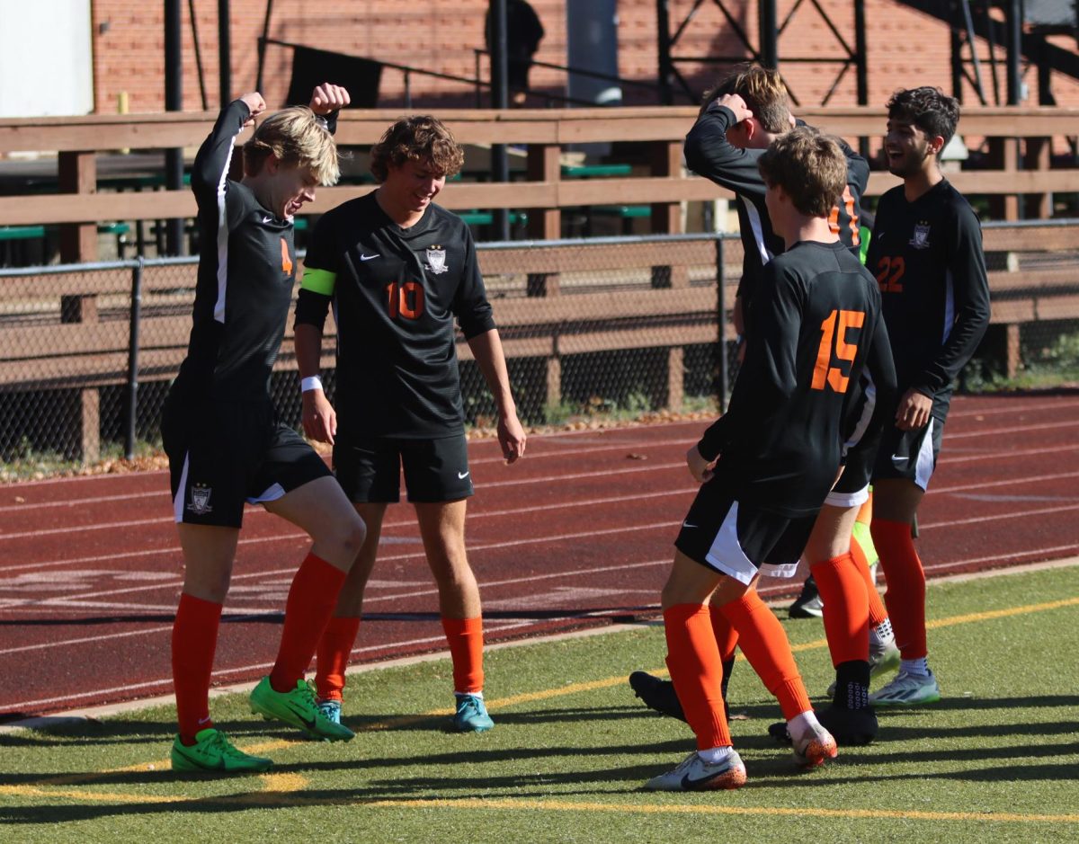 Juniors Kaden Dinges and Evan Wade celebrate after Dinges' goal, the second for the Falcons. The soccer team played Washington High school on Nov. 2, and defeated the Blue Jays 4-0 at Vianney High School. 