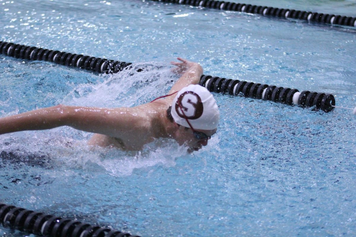 Freshman Brennan Lehmkuhl swims through the pool at the Summit Invitational on Oct 9