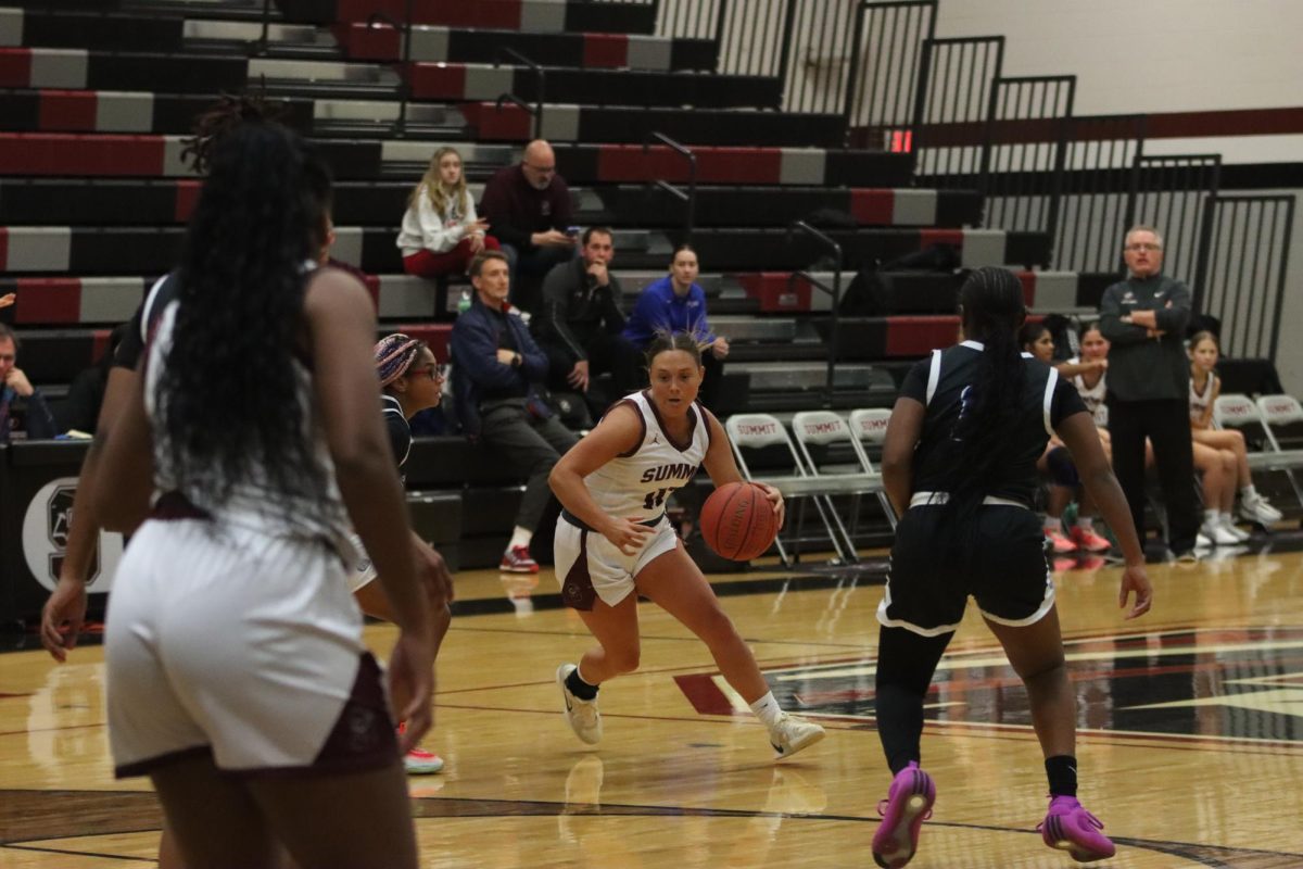 Senior Olivia Mantz dribbles the ball past STEAM Academy defender. The Falcons won 52-47 on Dec 7. 