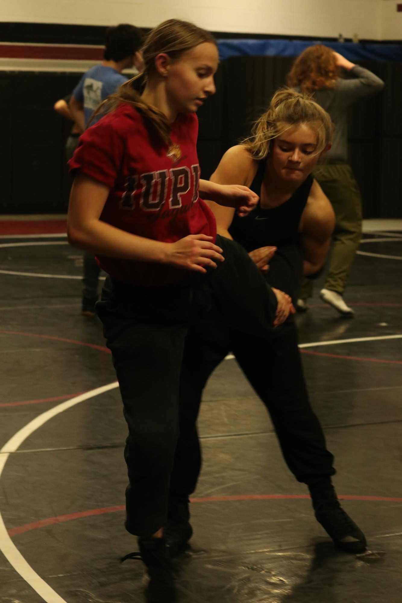 Freshman Autumn Anderson practices her techniques against junior Charlie Stanek during practice on Dec. 3.