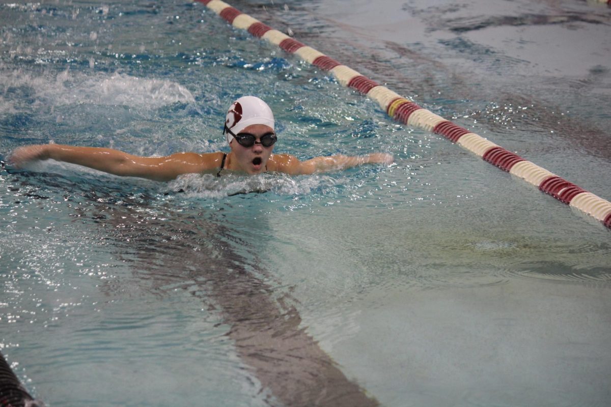 Freshman Caroline Kahn comes up for air in between strokes during the first meet of the season. The girls swim team won 106-64 against Pattonville on Dec. 3.