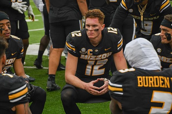 Quarterback Brady Cook sits with teammates while Missouri's defense takes the field against the University of Tennessee in 2023. Cook was named MVP of the 2024 Music City Bowl after 287 total yards of offense and two touchdowns.