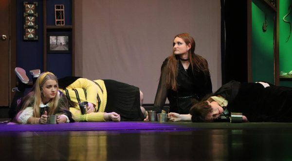 During the party scene, (from left to right) senior Aliza Carlson (Sally Perks), juniors Piper Covert (Hannah) and Mary Donovan (Megan Jones), and senior Parker Truman (Wayne Hopkins) act ‘sleepy’ after drinking Butterbeer. The Falcon Players’ production of Puffs! took place on Nov. 14 - 16 in the auditorium.