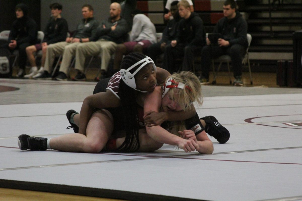 Freshman Kalena Gassoway looks to the referee as she pins CJ Sullivan of Union to the ground.