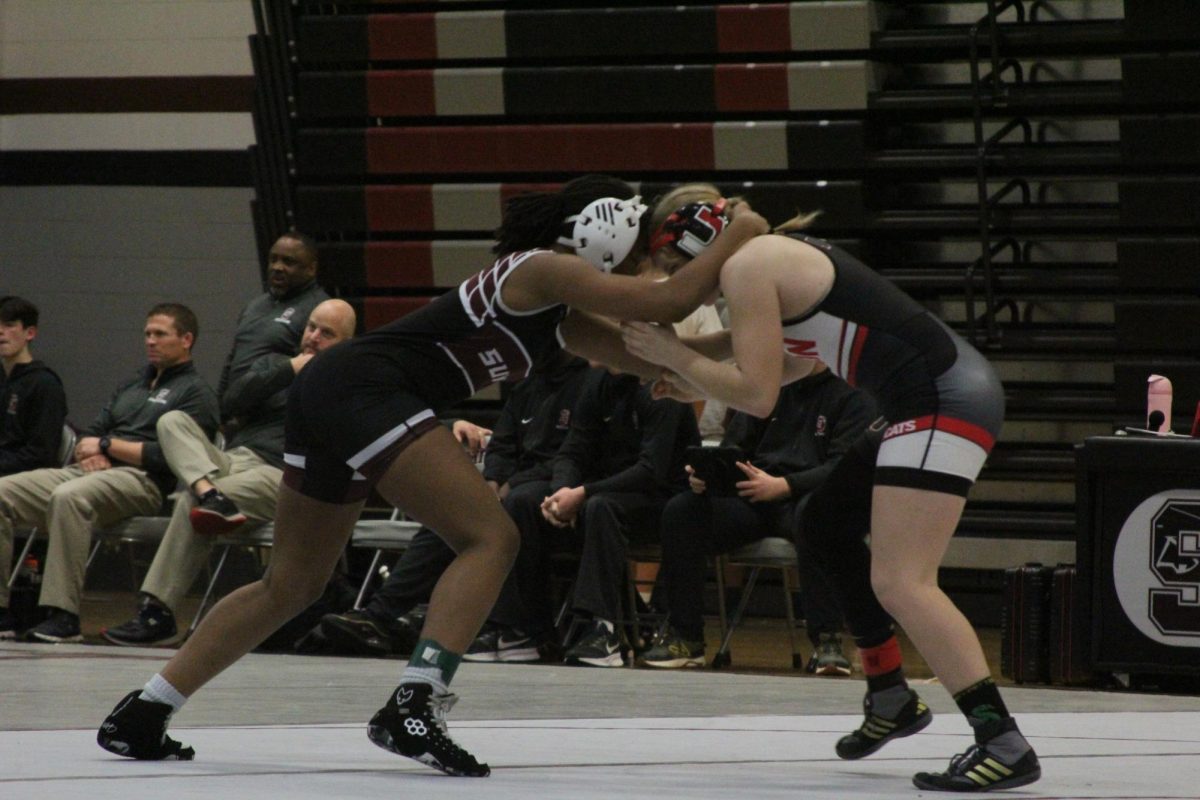 Freshman Myla Walker grabs the head of Union's Kaitlyn Kuelker as she attempts to find an opening.