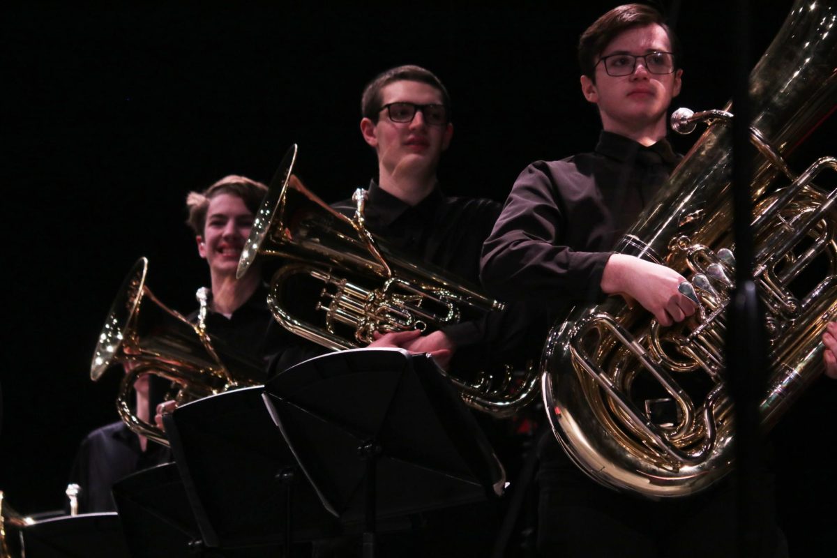 Looking at the band director, sophomore Jackson Matthews, senior Oliver lasdjlsf, and Junior Nolan sodijsdil get ready to play during the MMEA Practice Concert.