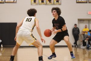 Looking for an open teammate senior Max Roth prepares to make a pass. The Falcons fell to the Vianney Griffins 88-50 on March 6. at the District 2 Quarterfinals.
