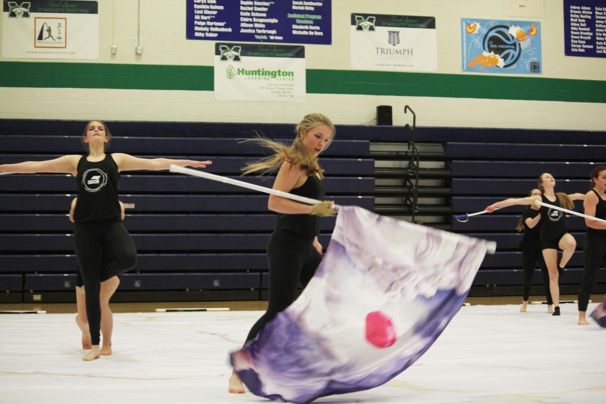 While swiftly catching her flag, sophomore Molly Jones performs her routine to "I Forgive You" by Sia during the Rockwood Review.
