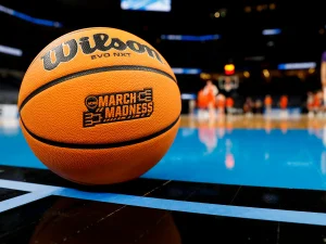In the illustration, a Wilson basketball sits on a court displaying the March Madness logo. (photo from USA Today)