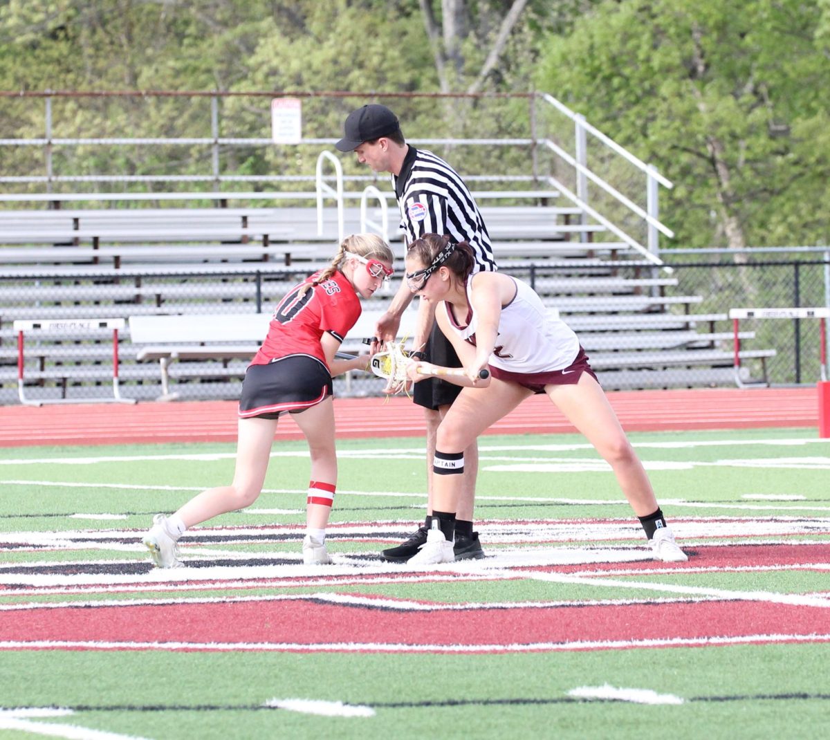 Senior captain Clodagh Kloos (2) takes the draw against Margot Newbold (10). The Falcons beat Visitation Academy 13-11 on April 25.