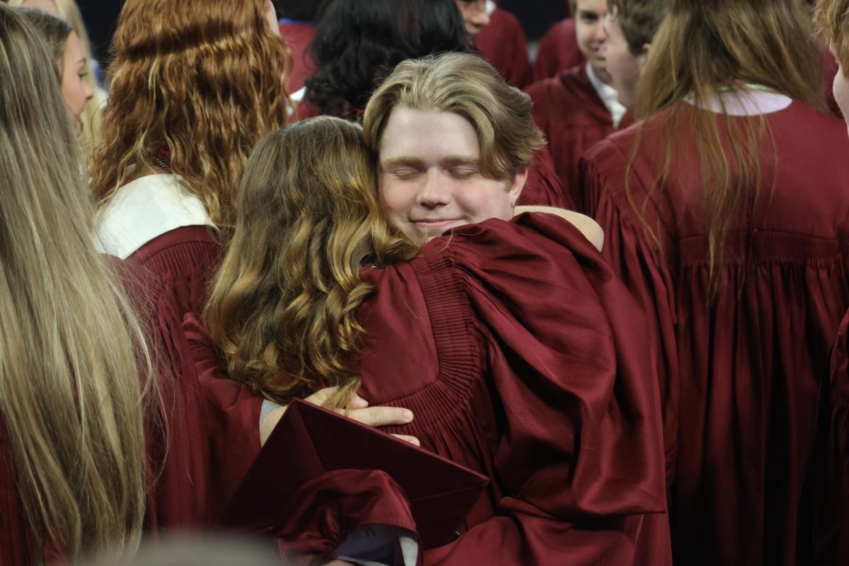 Seniors Finnley Free and Jonah Roberts embrace at the class of 2025 graduation ceremony. Graduation took place at the Family Arena on May 10. 