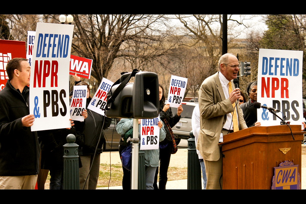 A Communications Workers of America  press conference being held across the street of the US Capitol building protesting for the federal support of funding National Public Radio and the Public Broadcasting System. (photo from the Denver Clarion)