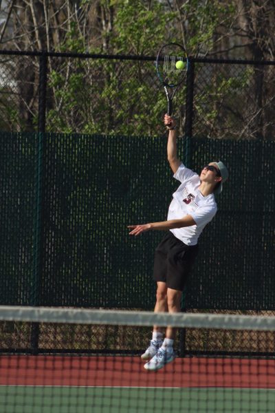 Junior Hiroki Fingerhut serves the ball to his Whitfield opponent on April 17. 