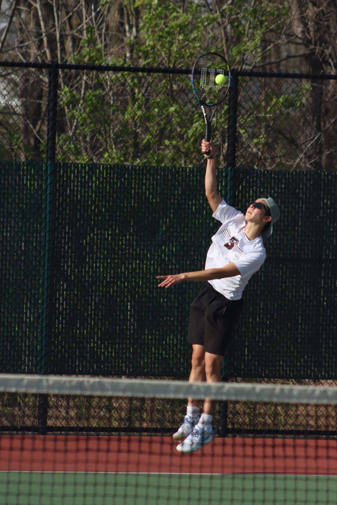 Junior Max Otto serves the ball to his Whitfield opponent on April 17. 