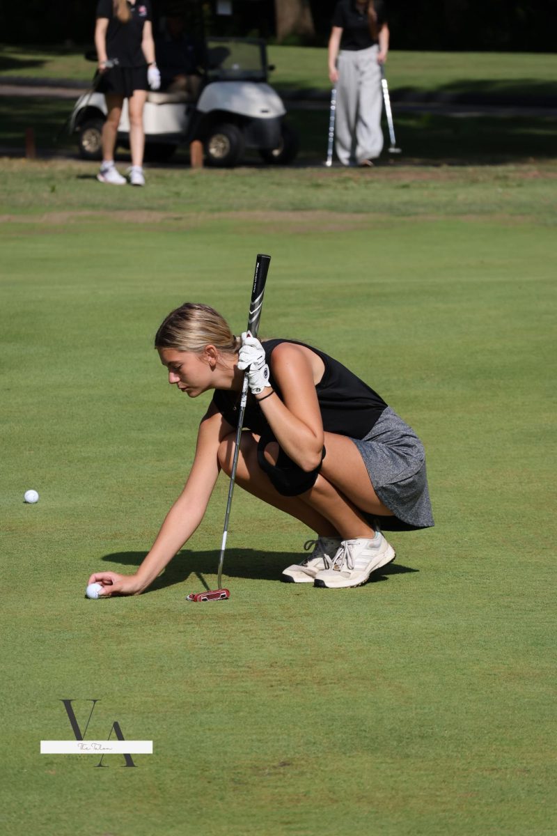 Senior Natalie Russo lines up her putt. Varsity girls golf took 10th place out of 23 teams on Sept. 9 at Crescent Farms. Russo shot an 83 and was awarded a medal. 