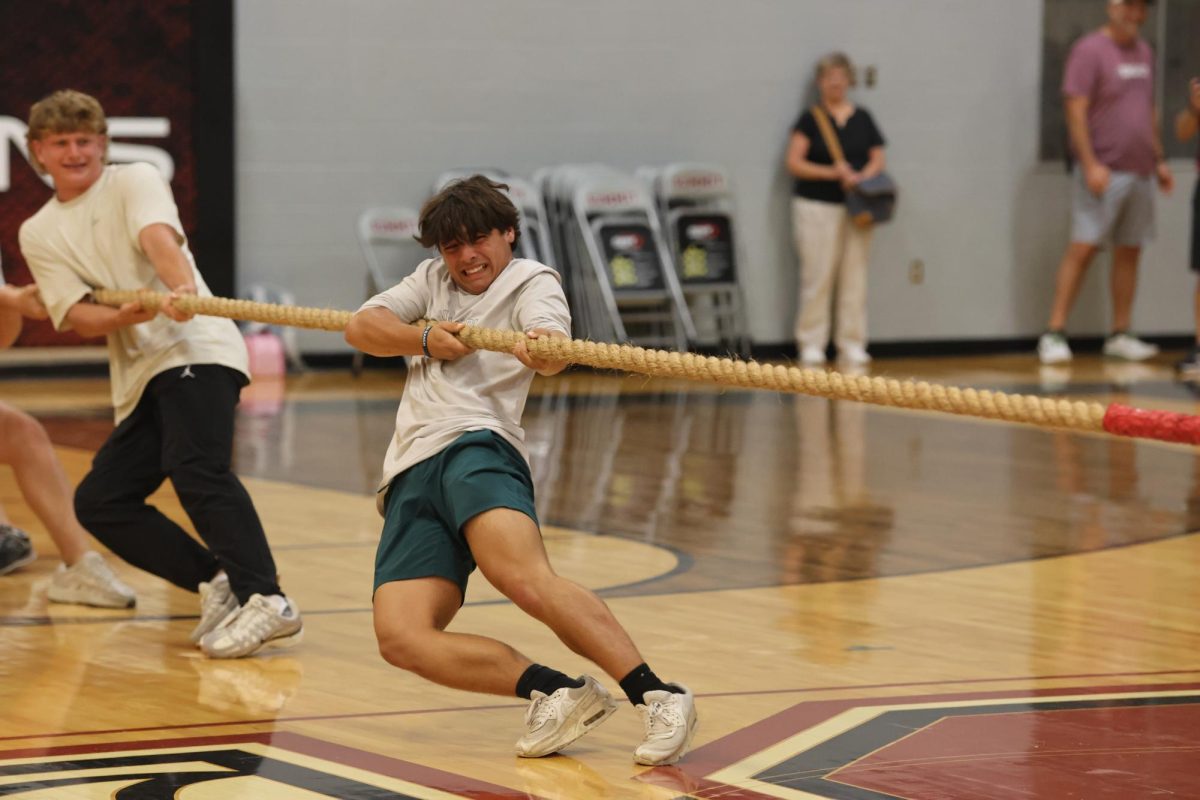 Pulling the rope, sophomore Anderson Tibbs helps his grade in a game of tug of war. 
