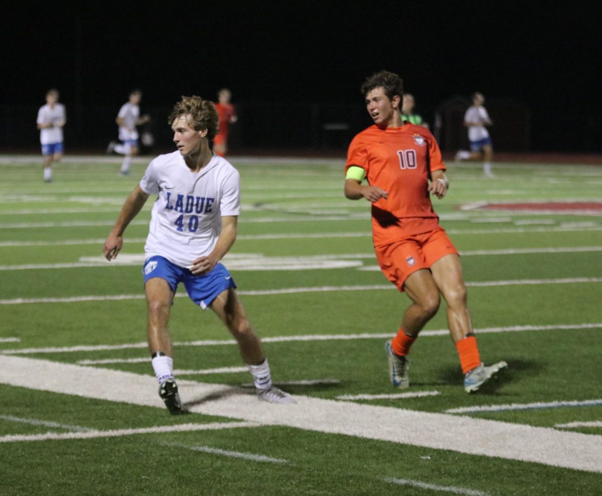 Turning around, senior Jack Steele (10) faces off against Luc Ozimkiewicz (40) of Ladue. The game took place on Sept. 6 and the Falcons defeated the Rams 1-0. 