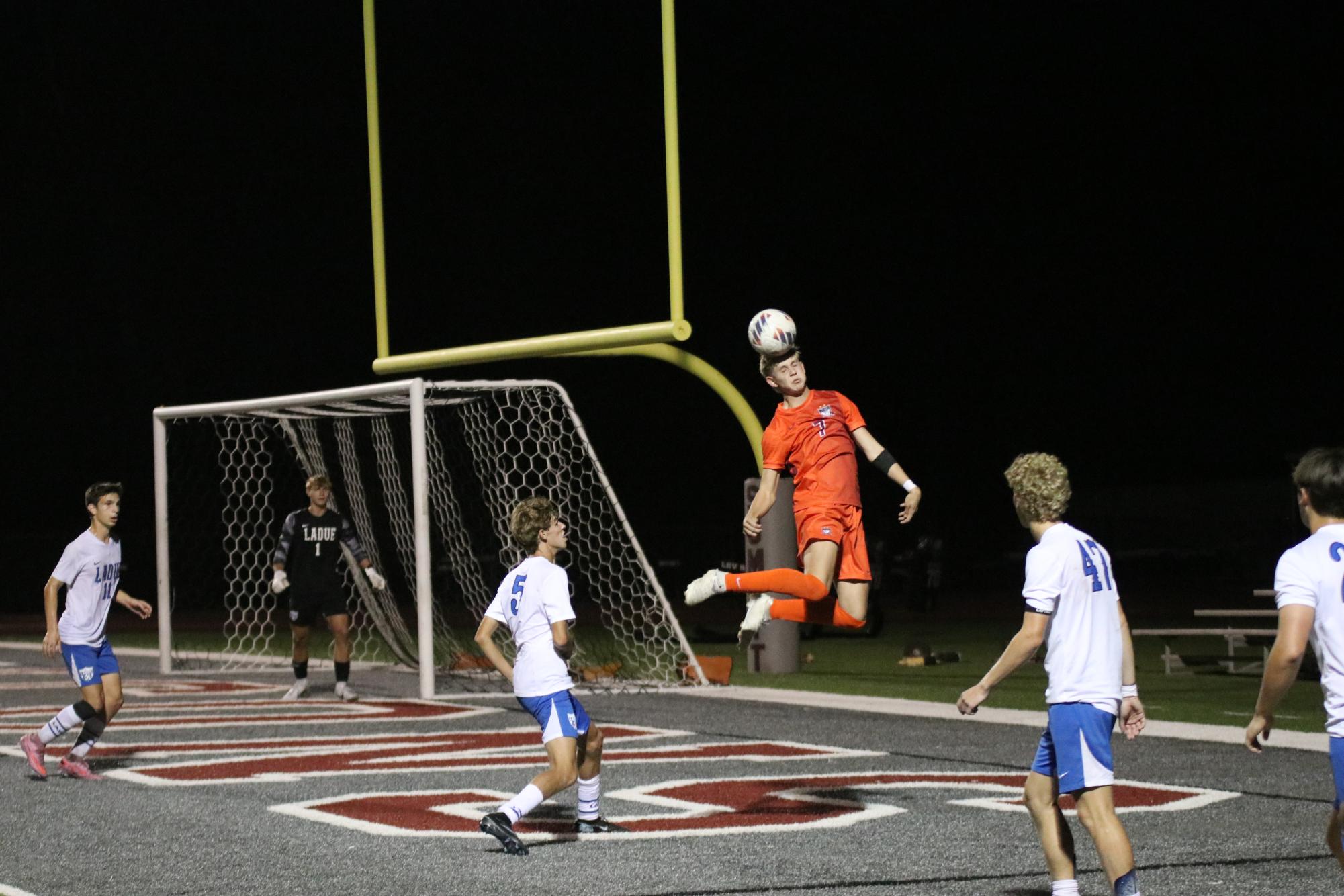 Flying through the air, senior Gavin Werner headbutts the ball. On Sept. 11, the boys varsity soccer team won 1-0 against Ladue. 