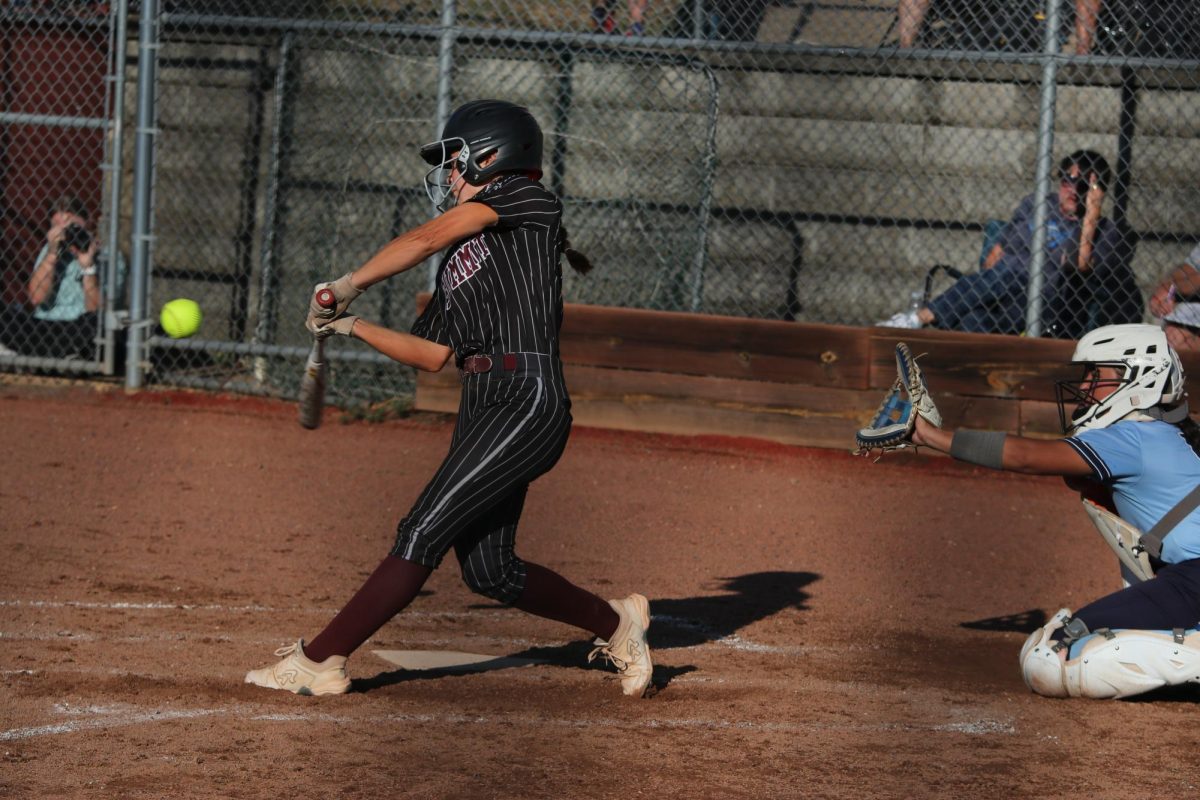 Swinging at the ball, senior Sarah Hou is at bat on Sept. 22. Summit Varsity Softball lost their game against St. Dominic 3-5.