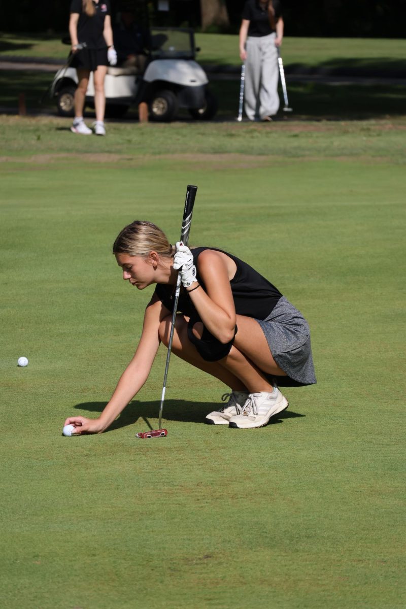 Senior Natalie Russo lines up her shot, as varsity girls golf took 10th place out of 23 teams at Crescent Farms on Sept. 9.