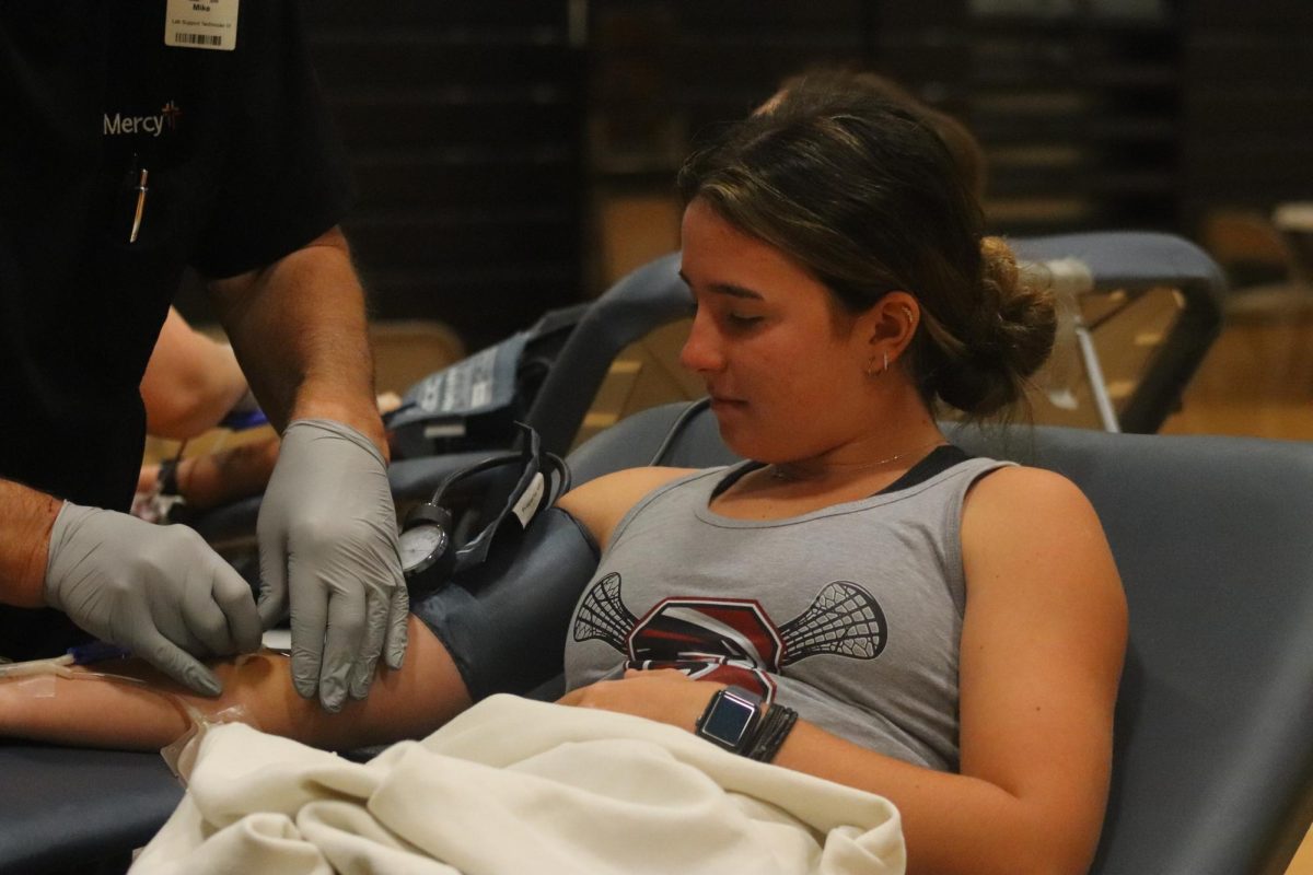 Junior Georgia Teller watches as she gets her blood drawn.