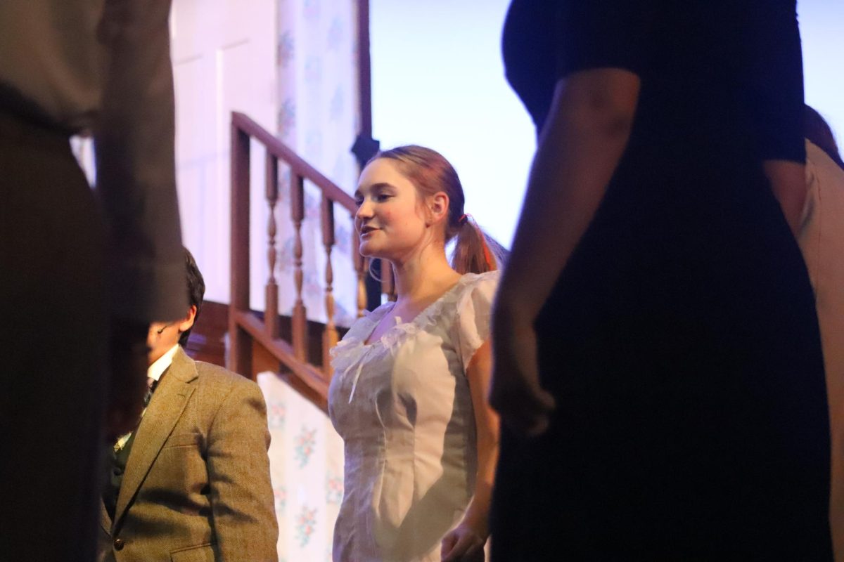 Senior Mary Donovan leads the rest of the actors in a warm up before rehearsal. The play took place on Nov. 13-15.
