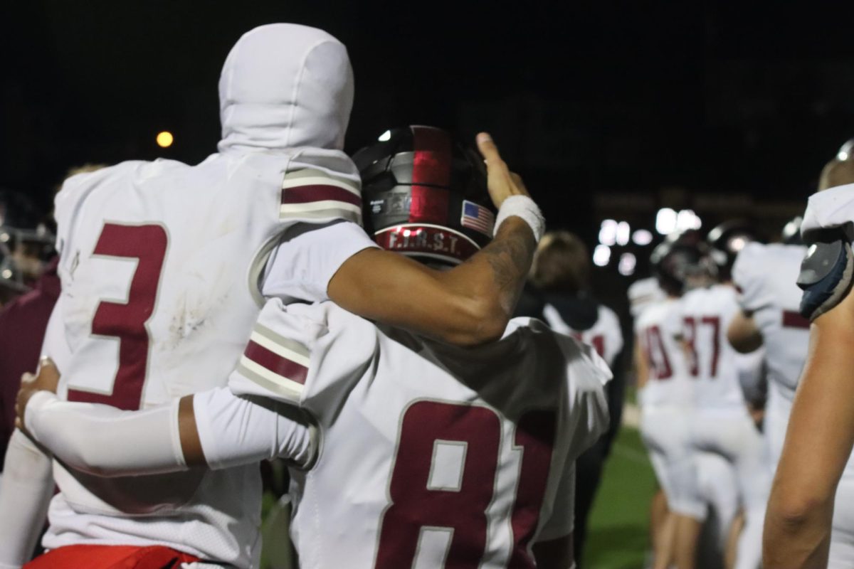 Senior Jasahn Tiller (3) and freshman Kaden Carron (81) stand with their arms around each other. The game took place on Nov. 7, with the Falcons losing to Eureka 21-3, ending their district run.
