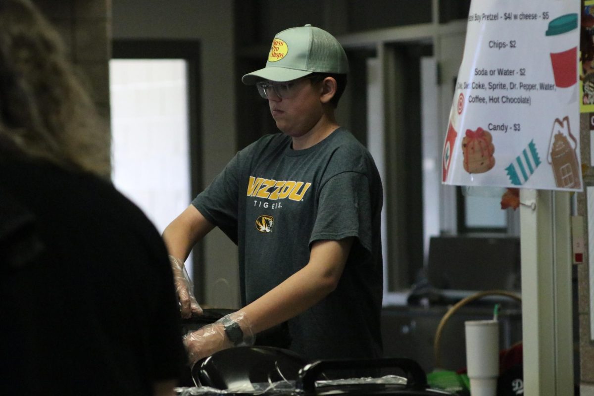 On Nov. 15, senior William Vonderhaar works the craft fair’s concessions. Vonderhaar was one of many band students who volunteered their time to help run the craft fair.
