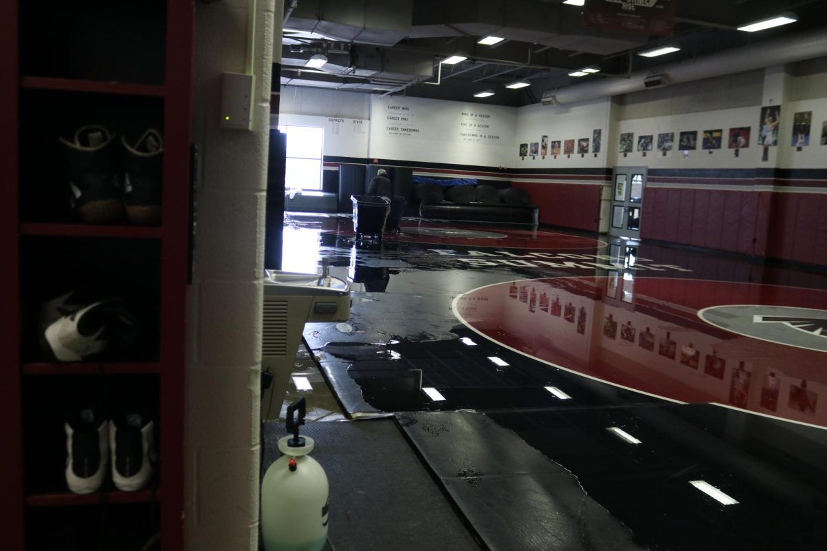 The wrestling room sits covered in water. On Nov. 17, a sprinkler was set off in the wrestling room during second lunch. 