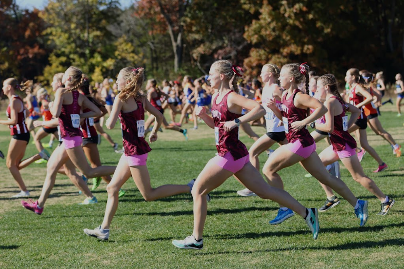 After the gun, freshman Lauren Boyher, seniors Audrey Venneman and Nika Gilbert, junior Molly Jones, and sophomore Abigail James run together at the start of the race.