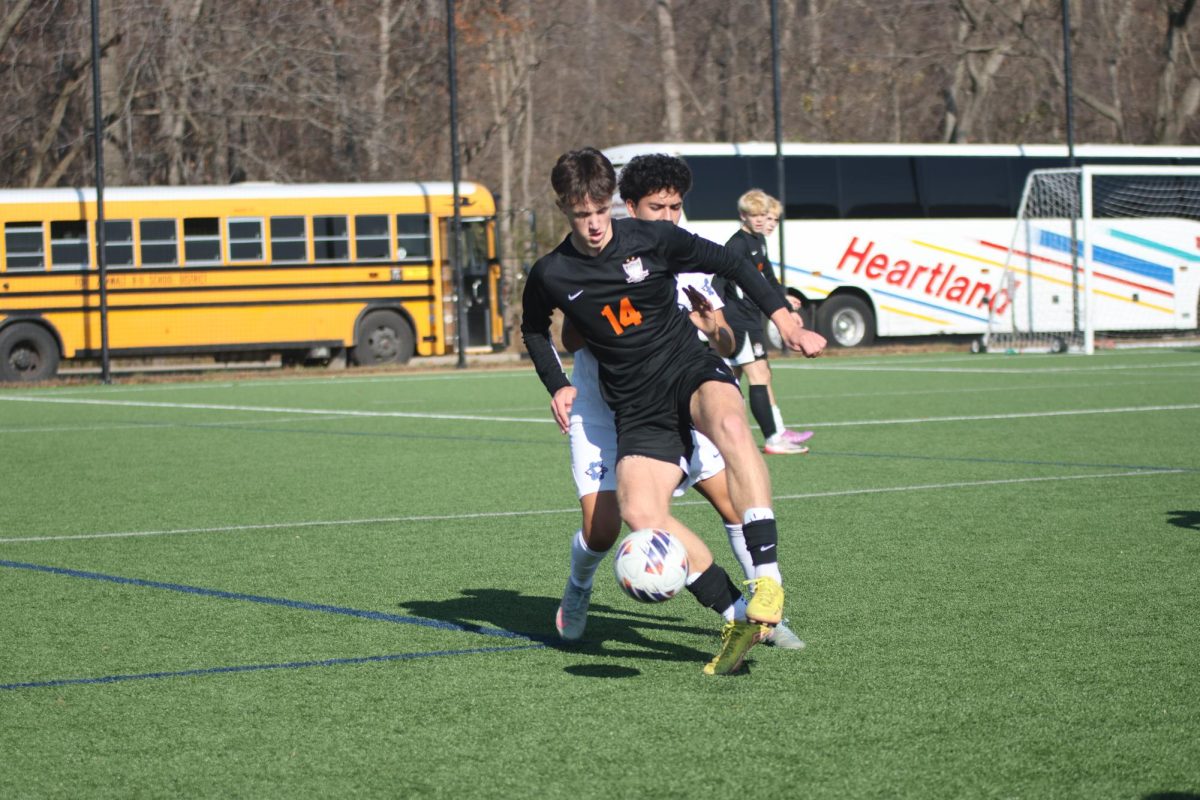 Dribbling the ball, junior Harper
Edwards fights against Summit
Christian Academy’s Troy
Warfield. The Falcons won 6-0 and
claimed third place on Nov. 22.