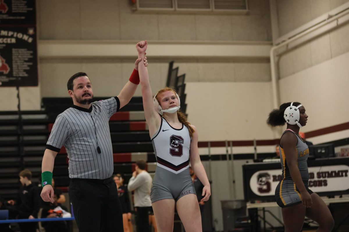 Holding her hand up in victory, freshman Delaney Pye takes the match.