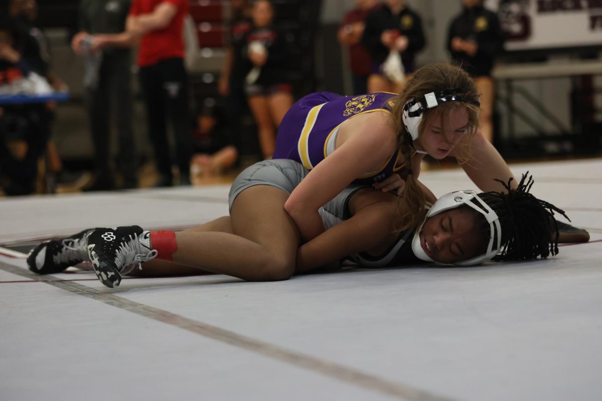 Sophomore Myla Walker gets held down by her opponent. The tournament, hosted by Summit, hosted 22 teams on Jan. 16.