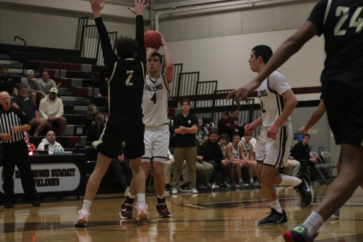 Facing off against  Ermin Imamovic (2) of Oakville, senior Oliver Puljic (4) shoots the ball. The game took place on Jan. 6, the Falcons defeating the Tigers 83-52.