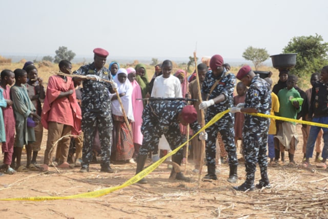The scene of one of the airstrikes is blocked off by Nigerian police. This site in Northwest, Jabo, Nigeria, was one of the many hit during the strikes (photo from Council on Foreign Relations/Associated Press).