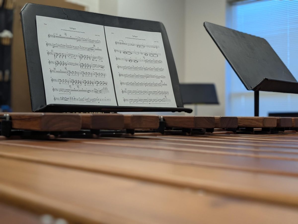 Sheet music of the piece "Epilogue" sits on a stand. The piece was written by senior Justin Tang for the percussion to play at their concert.