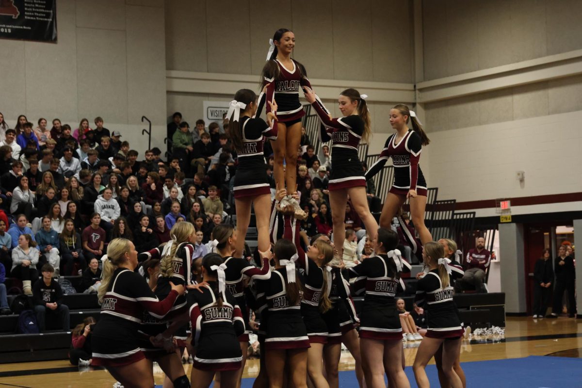 During the annual winter pep rally on Jan. 23., the cheer team performs a stunt in front of the student body, lifting junior Sami Fadley into the air. 
