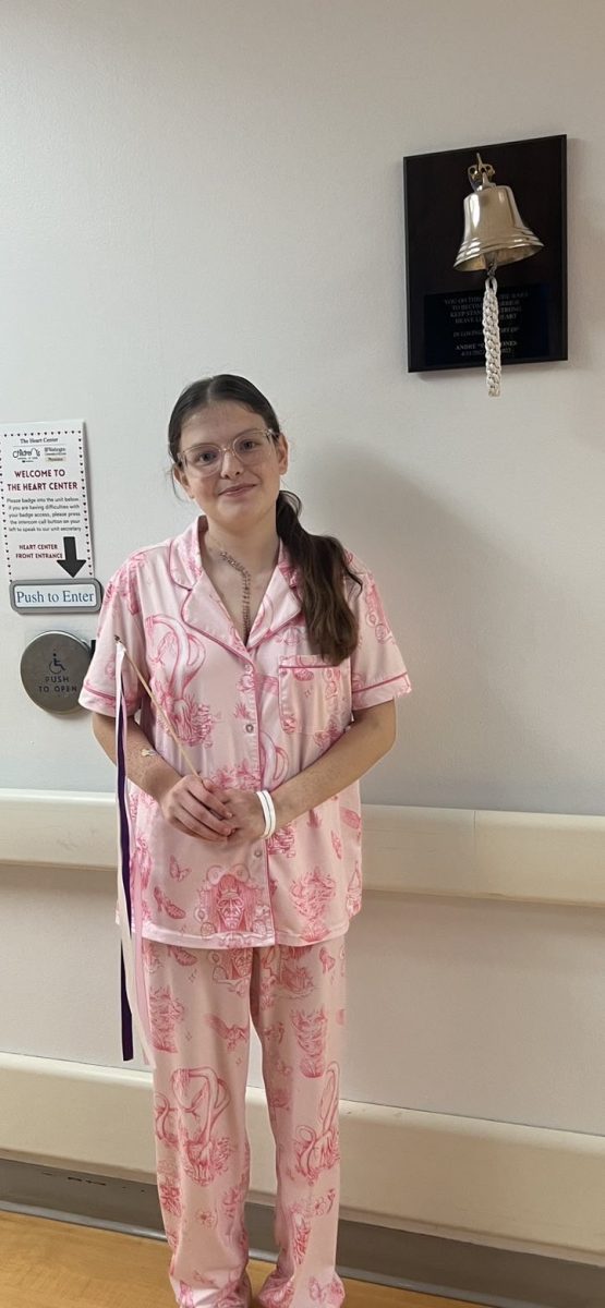 Senior Macey Brown poses for a photo after ringing the bell in celebration of being discharged from hospital. (photo used with permission from Brown)