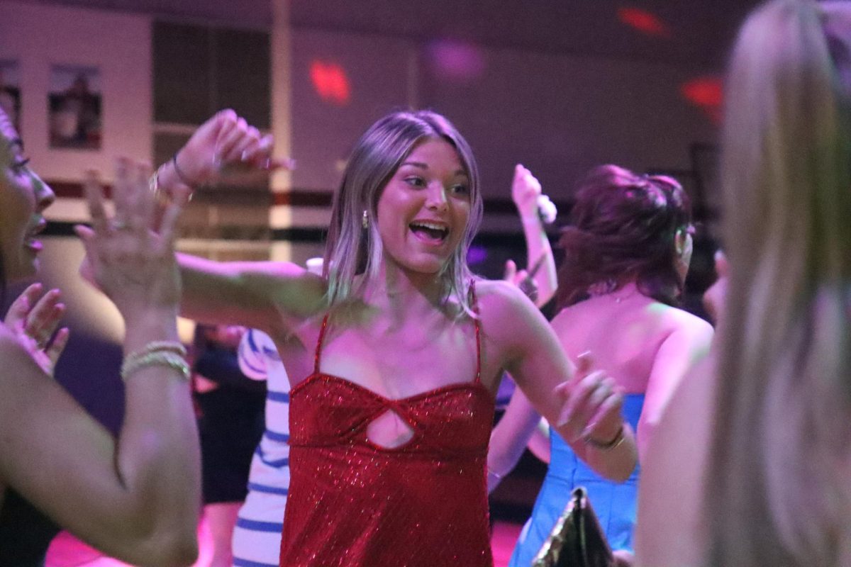 Dancing to the music, senior Maria Domian parties with her friends. The Winter Dance took place on Jan. 31. 