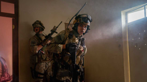 Peering around a corner, Ray (D’Pharaoh Woon-a-Tai) looks in worry in a scene from “Warfare.” The film, among many others, went overlooked for nominations for the Academy Awards. (photo from NPR)