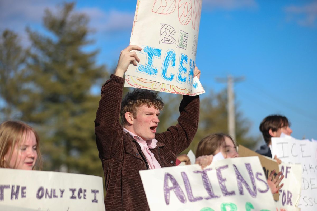 Holding a sign among other student protestors, senior Logan Martin chants during Lafayette’s anti-ICE walkout. Lafayette students left their 6th hour classes on Feb. 6 to bring attention to the actions of ICE across the US. (photo used with permission by Darby Morel)