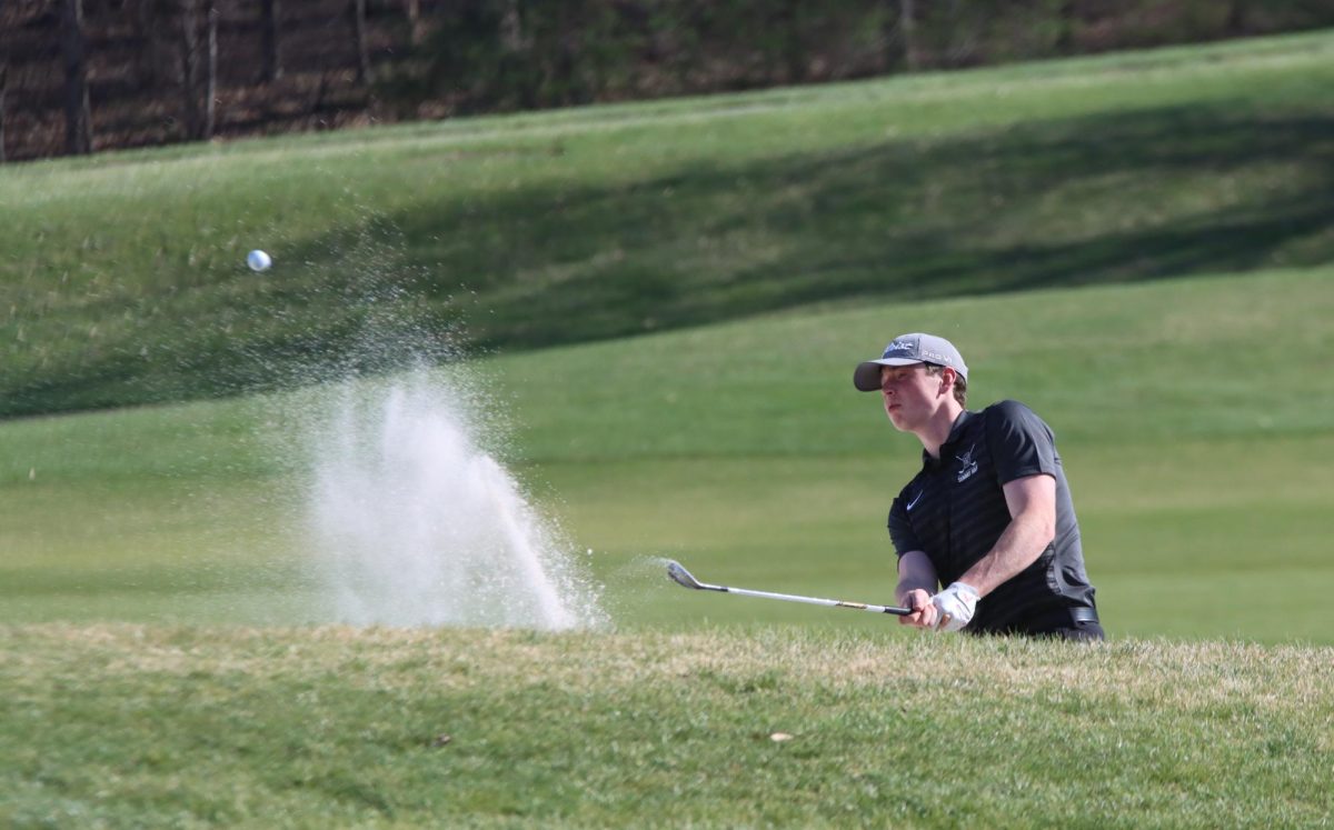 Senior Michael Potteiger hits his ball out of the sand. The Boys Varsity Golf team played against Eureka at The Legends Country Club on March 26.
