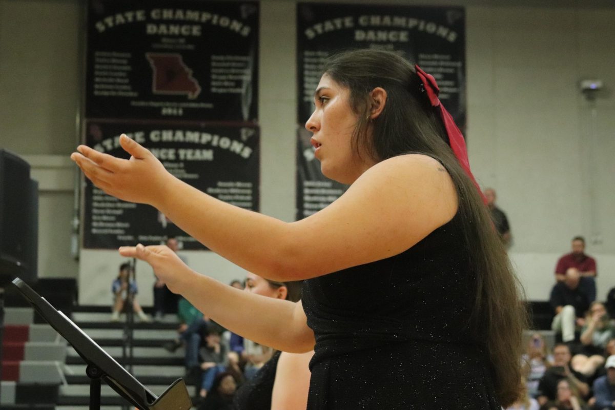 Senior Mackenzie Moreno conducts the choir during the song "We Will Rise Up Together." The concert took place on March 25.
